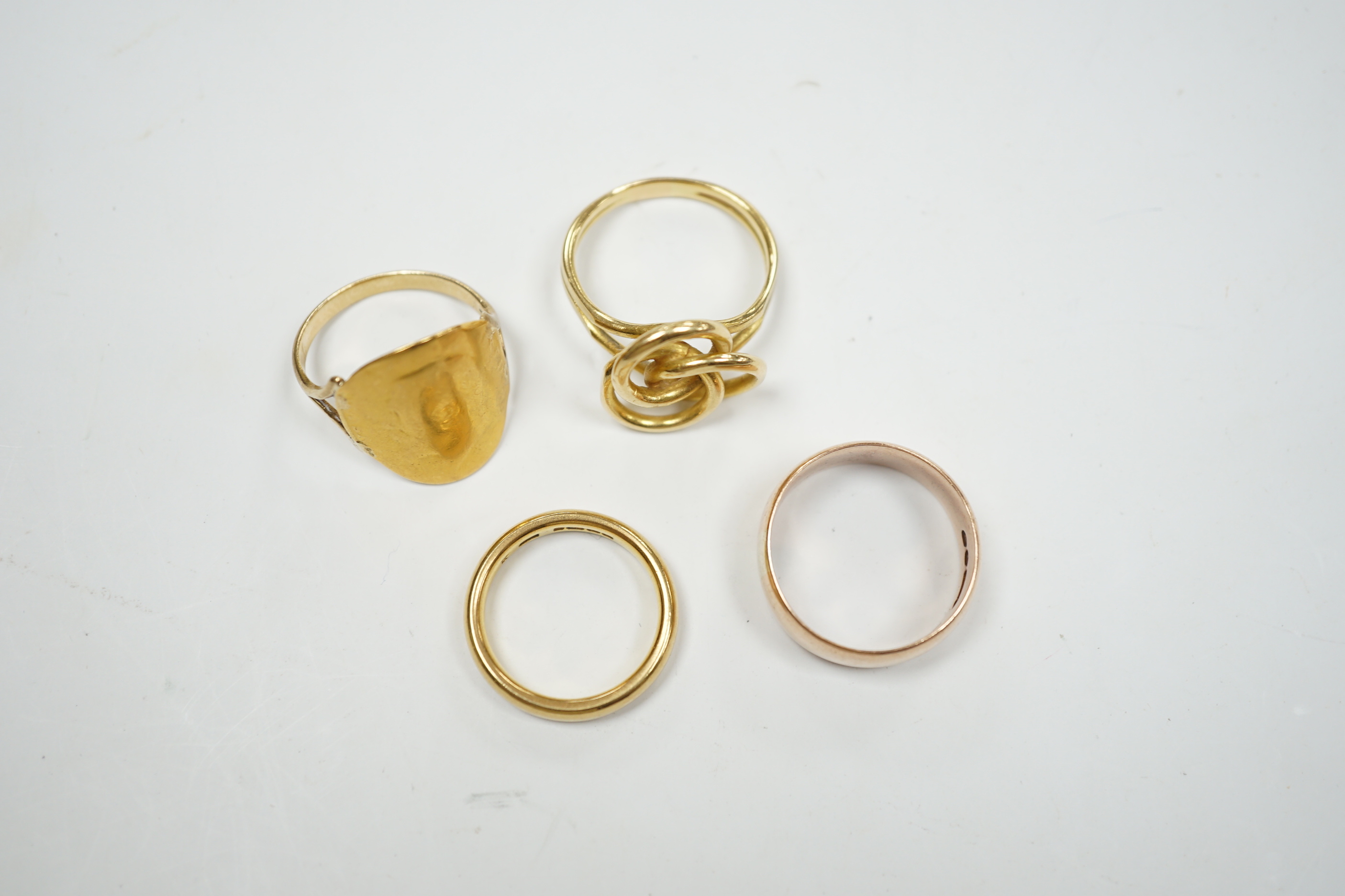 A 1930's 22ct gold wedding band, 5.9 grams, a 9ct gold wedding band, 5.1 grams and two other yellow metal rings, 10.1 grams.